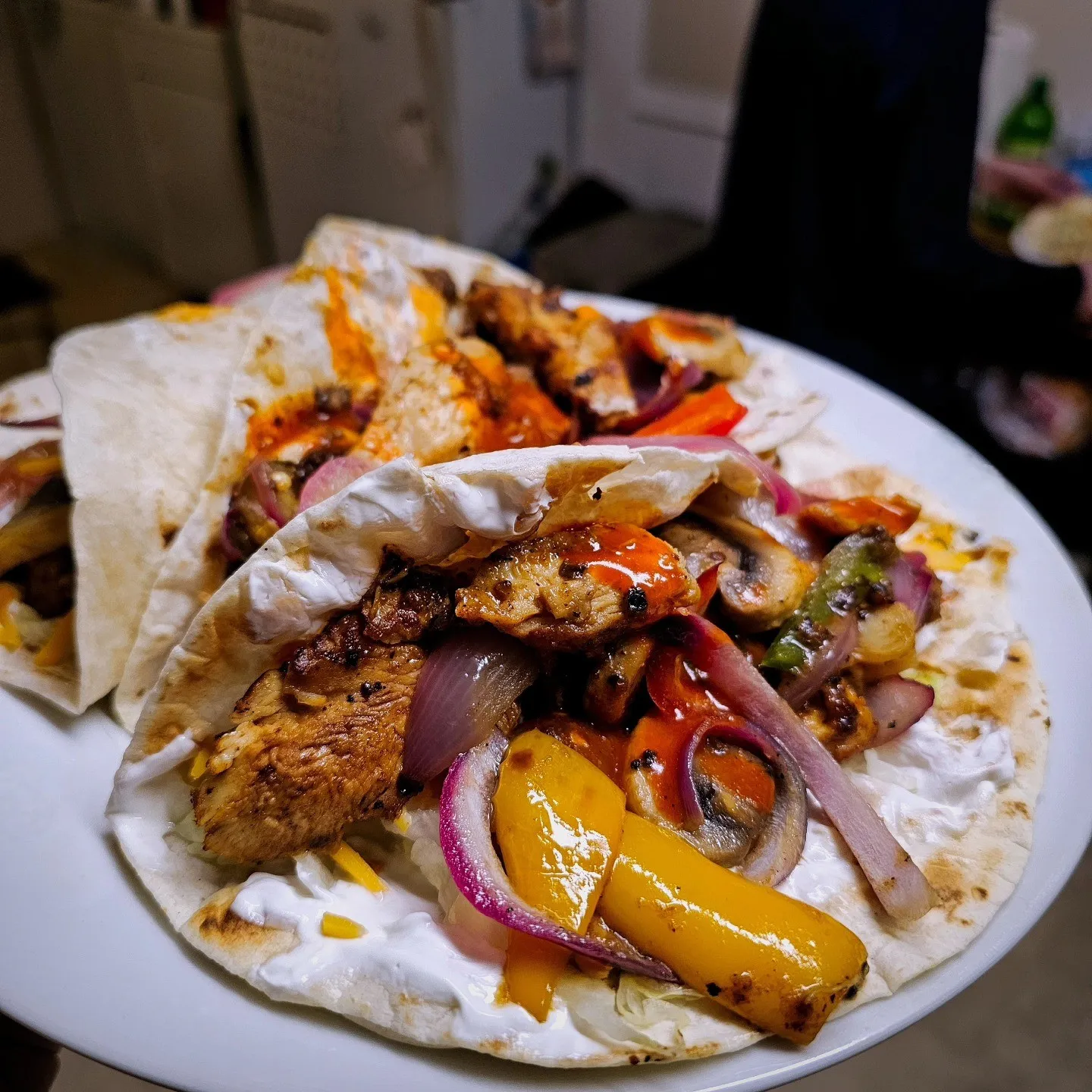 Soft tortillas filled with browned strips, peppers and red onions.